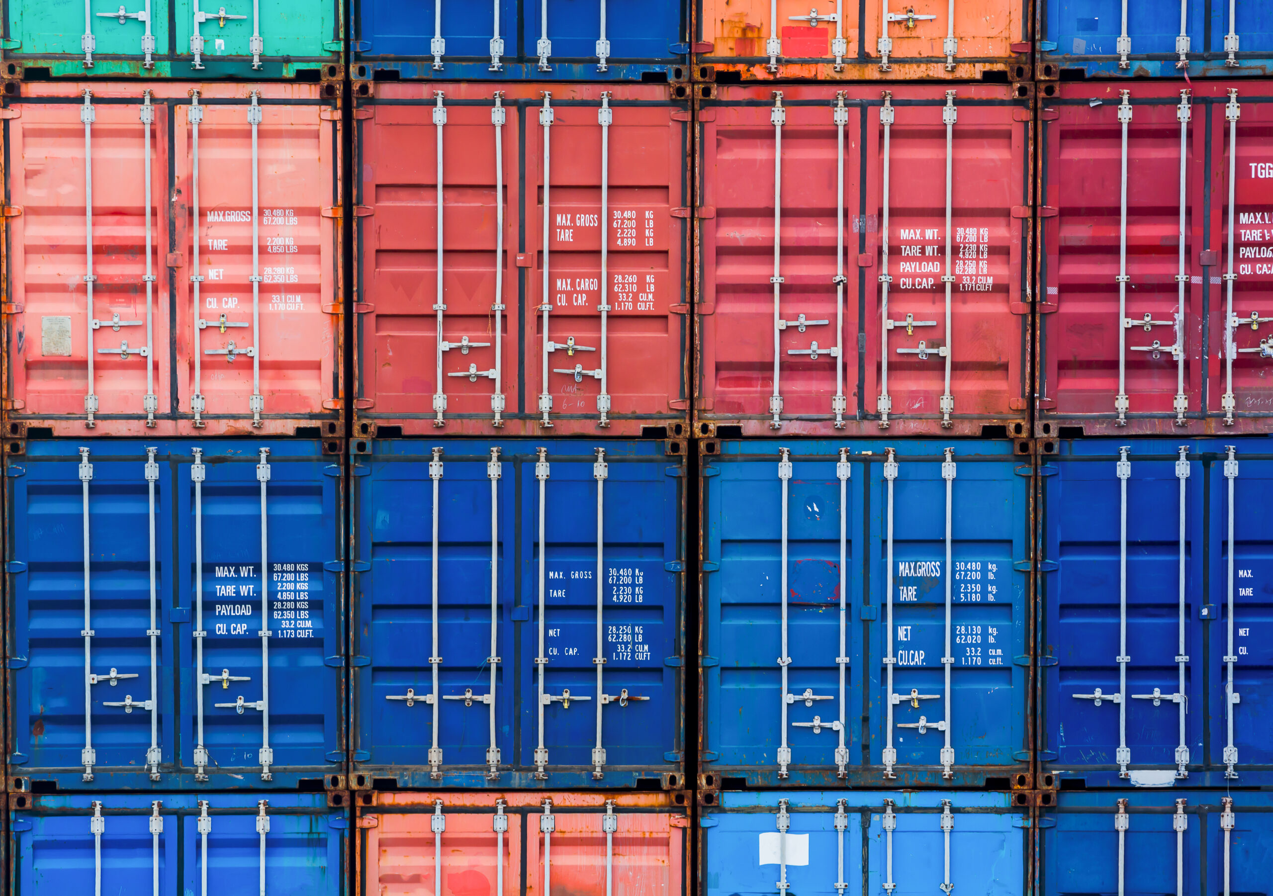 Four,Vertical,Rows,Of,Shipping,Containers,That,Are,Different,Colors